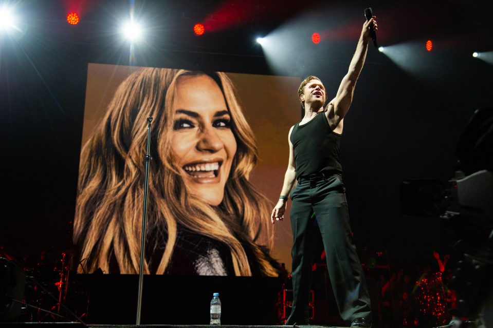 Olly Murs performing on stage at a music festival.