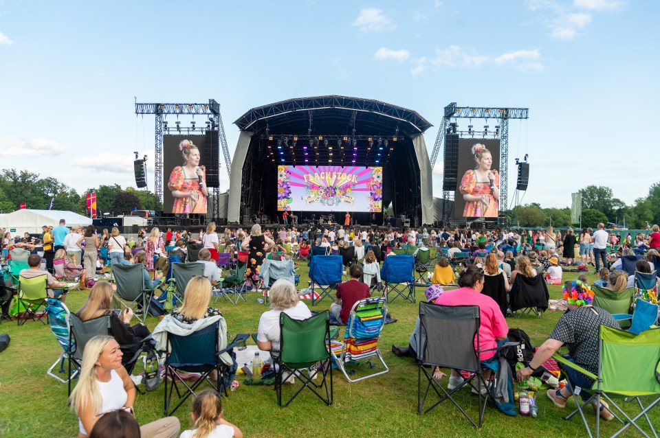 General view of the main stage at Flackstock, with a large audience seated on the lawn.