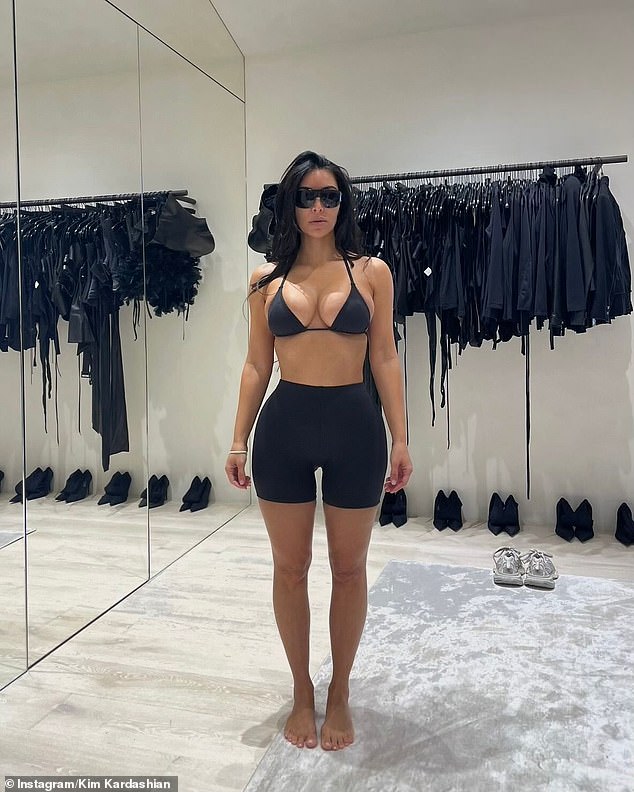 The ex-wife of Kanye West had her raven hair down with no makeup on as she tried on some new SKIMS designs in a deep black color