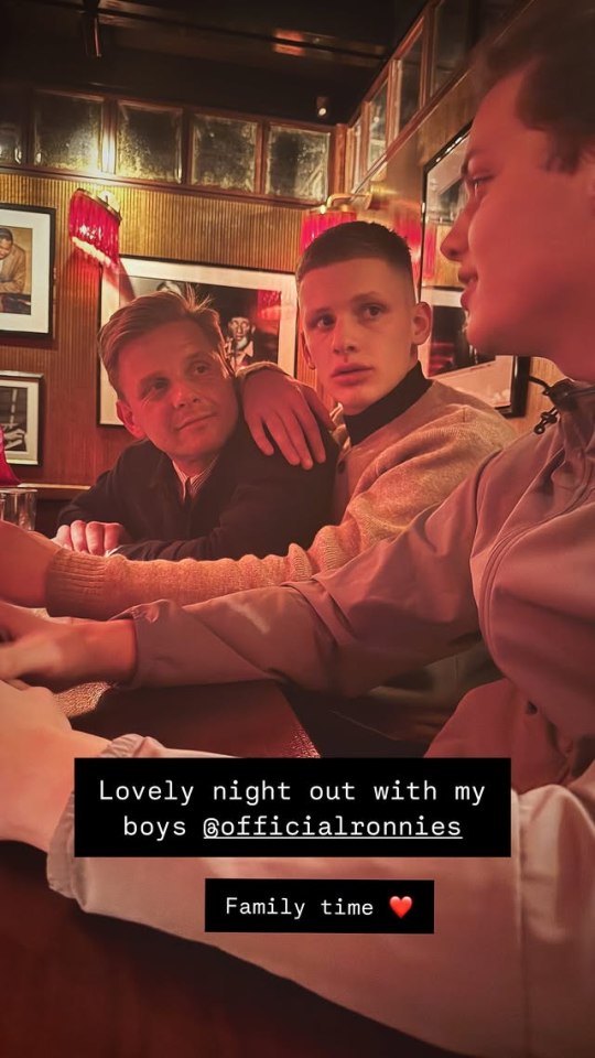 A man and two young men sitting together at a restaurant.