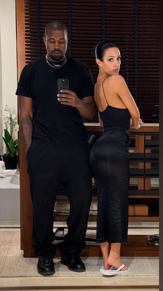 Kanye West and Bianca Censori in black outfits.