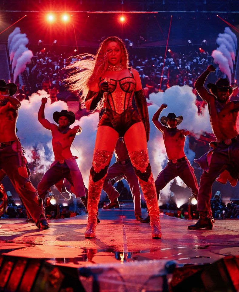 Beyoncé performing on stage with backup dancers.