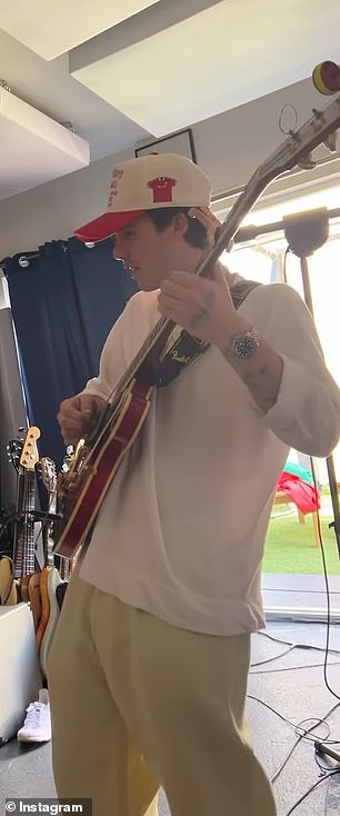 The musician, 20, looked his element as he strummed his guitar in front of the camera