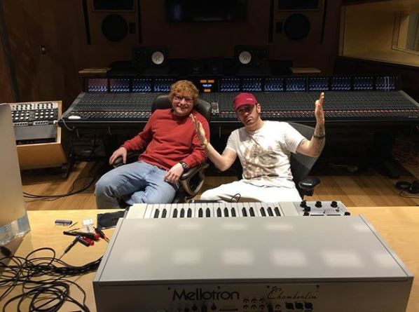 Two men sitting in a recording studio in front of a Mellotron Chamberlin keyboard.