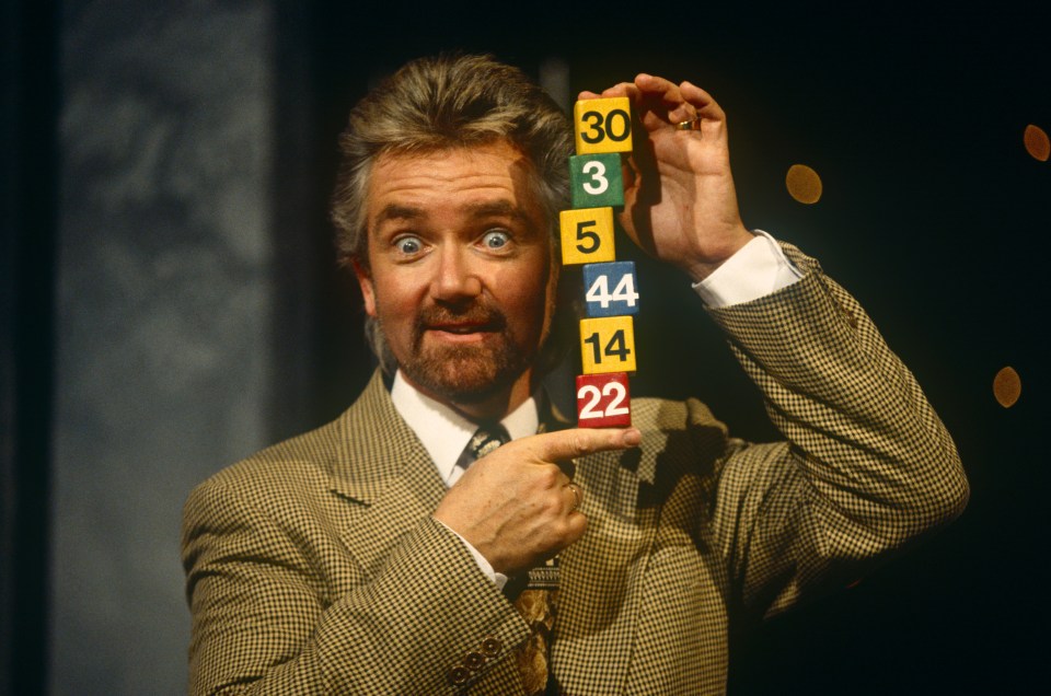 Noel Edmonds and his wife Liz Davies stand outside a pub.