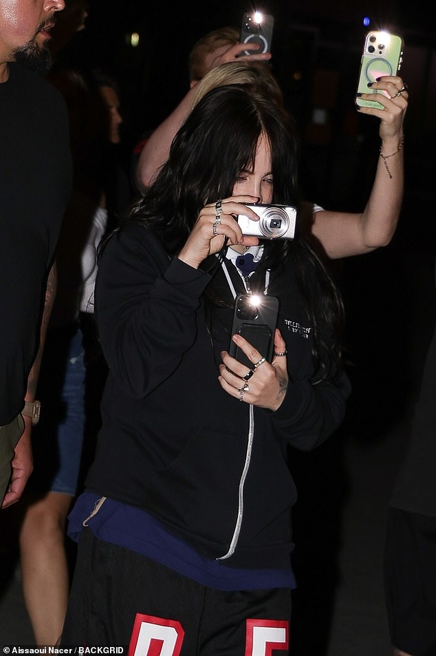 The 23-year-old singer¿songwriter was spotted after her dinner with friends as she descended the tower and captured the magical moment on a Canon Powershot camera