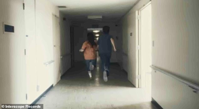 In the video, Eilish is seen making her way down a series of hallways in a drab institutional building, eventually convening with Wolff