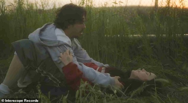 The 'inescapable connection' between the two described by Eilish is depicted as they make their way out of the building and into a grassy field, where they playfully wrestle and eventually embrace one another