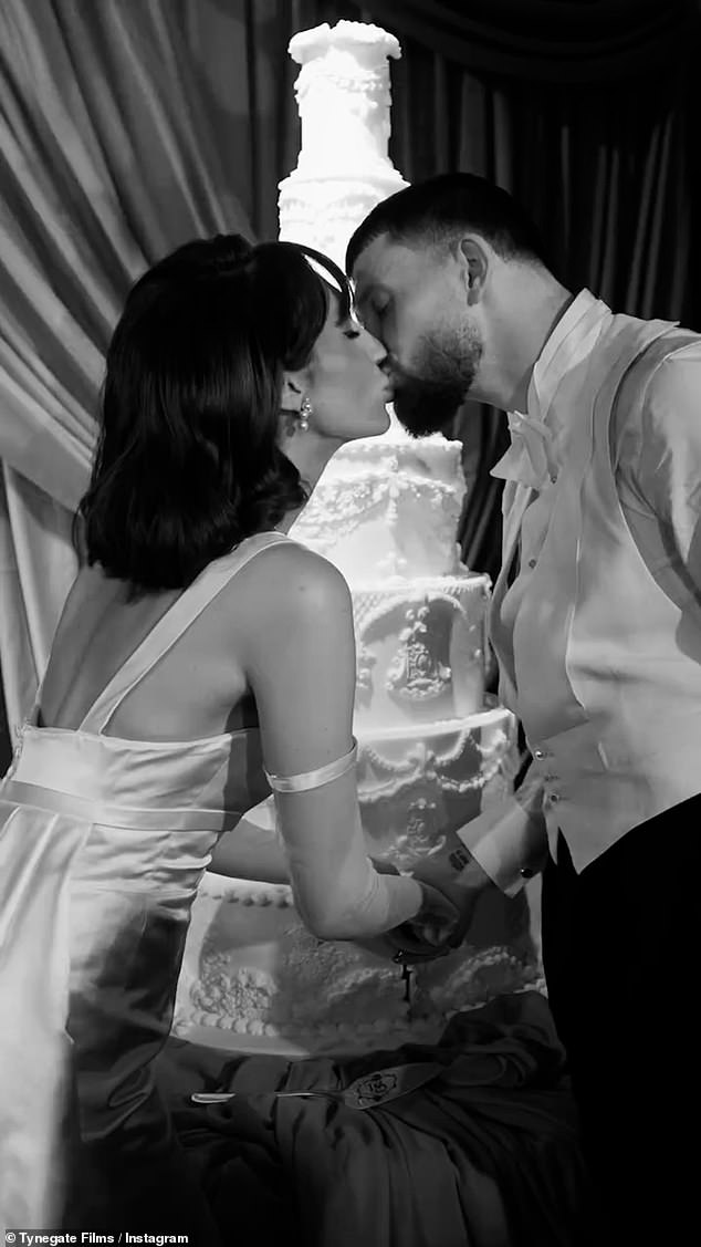 The couple then shared another passionate kiss as they cut their jaw-dropping seven-tier cake in front of their wedding party