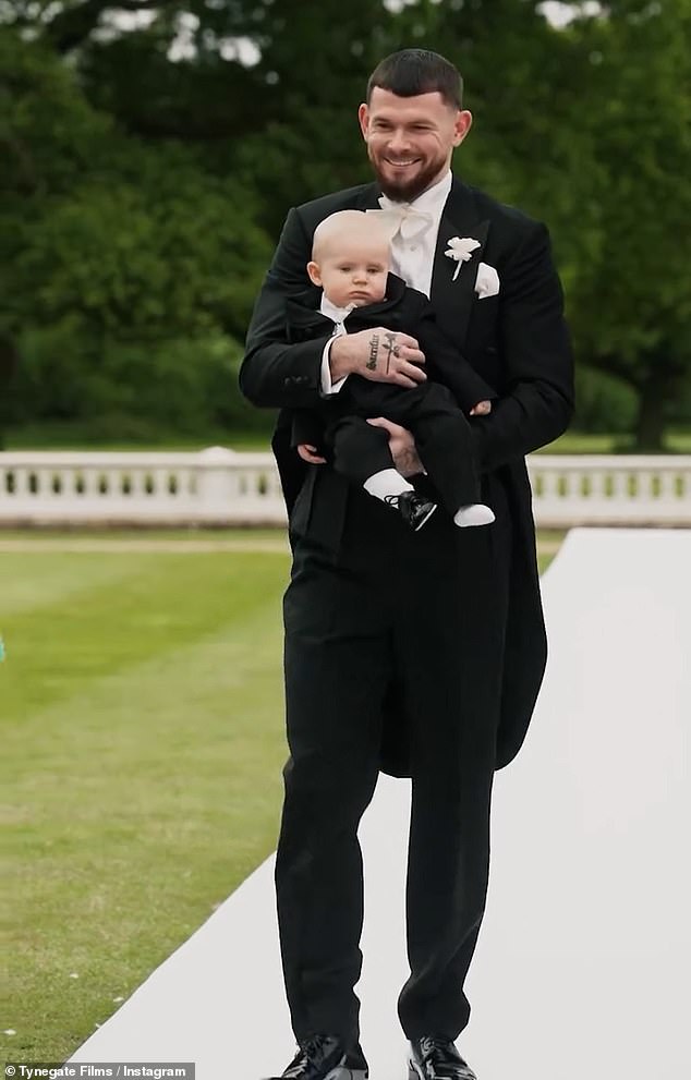 The Scottish pro footballer looked incredibly dapper in a black tuxedo as he held his son Landon, who looked adorable in a matching black suit, in his arms