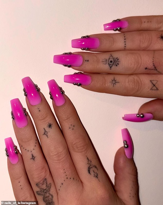 'The two-tone pink aura keeps it soft, and the double chrome studs give it that Prince Albert edge,' she continued, referencing to phallic 'Prince Albert' piercings