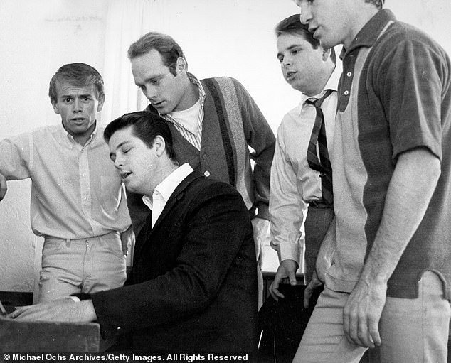 Wilson (second from left) is pictured with the other Beach Boys in 1964