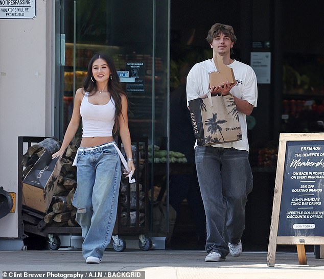 The pair, both wearing white sneakers, jeans and white tops, were photographed at the upscale Calabasas grocer Erewhon toting brown paper grocery bags