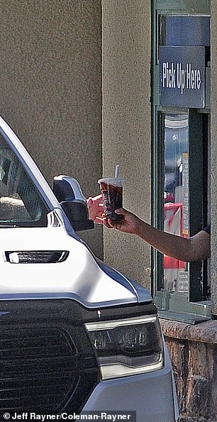The McDonalds worker hands Selleck his soda