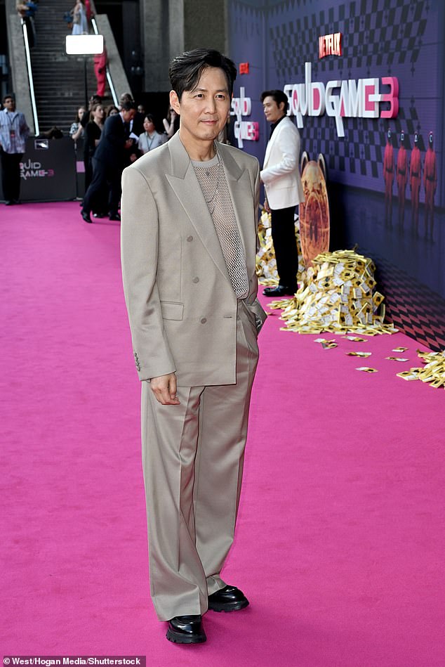 He wore a silver fishnet top, teamed with a beige blazer, matching trousers and chunky black loafers