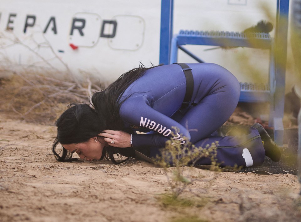 Katy Perry kissing the ground after a Blue Origin space flight.