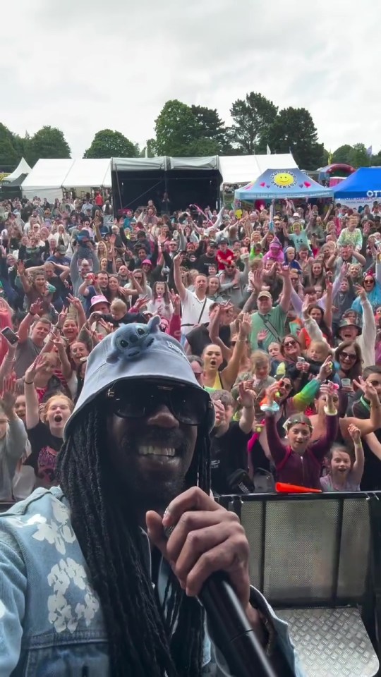 General Levy performing at a music festival in front of a large crowd.