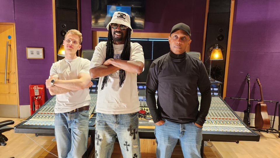 General Levy with two other men in a recording studio.