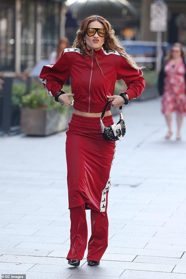 The singer appeared in very high spirits as she struck a silly pose for the cameras before making her way into the studio