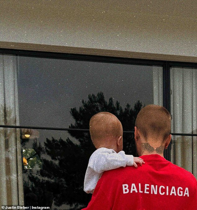 Justin and his son appeared to be on the grounds of his sprawling mansion