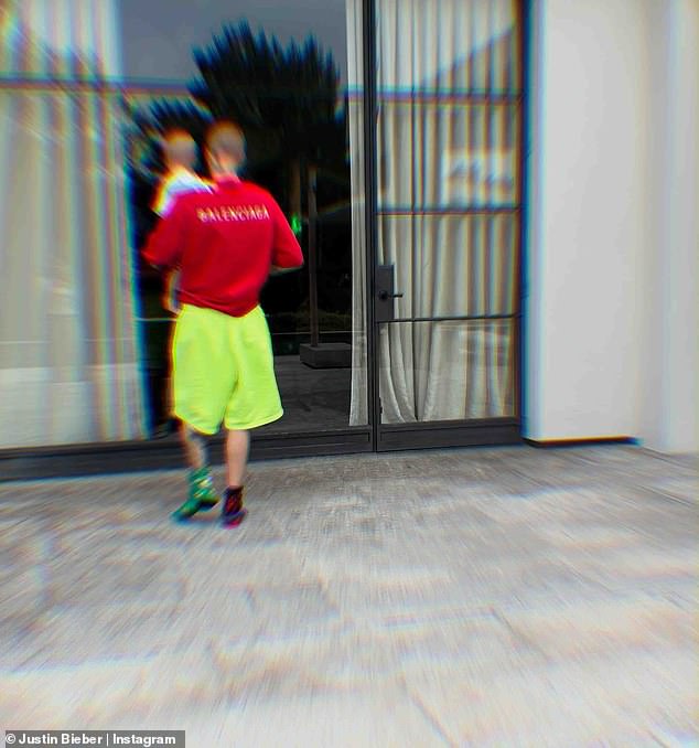 Bieber teamed his casual look with highlighter-green shorts and mismatched socks