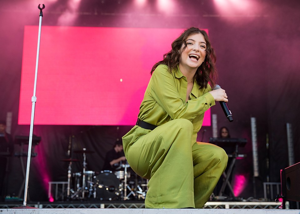 Lorde performing on stage.