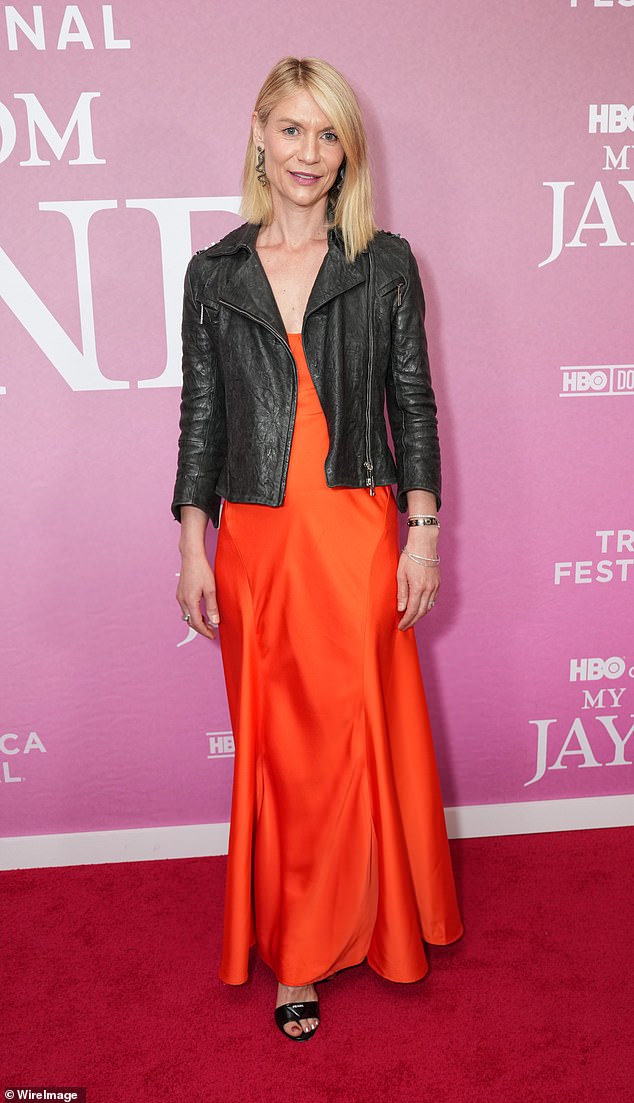 Claire Danes looked lovely in a bright orange dress and shrunken, black leather moto jacket