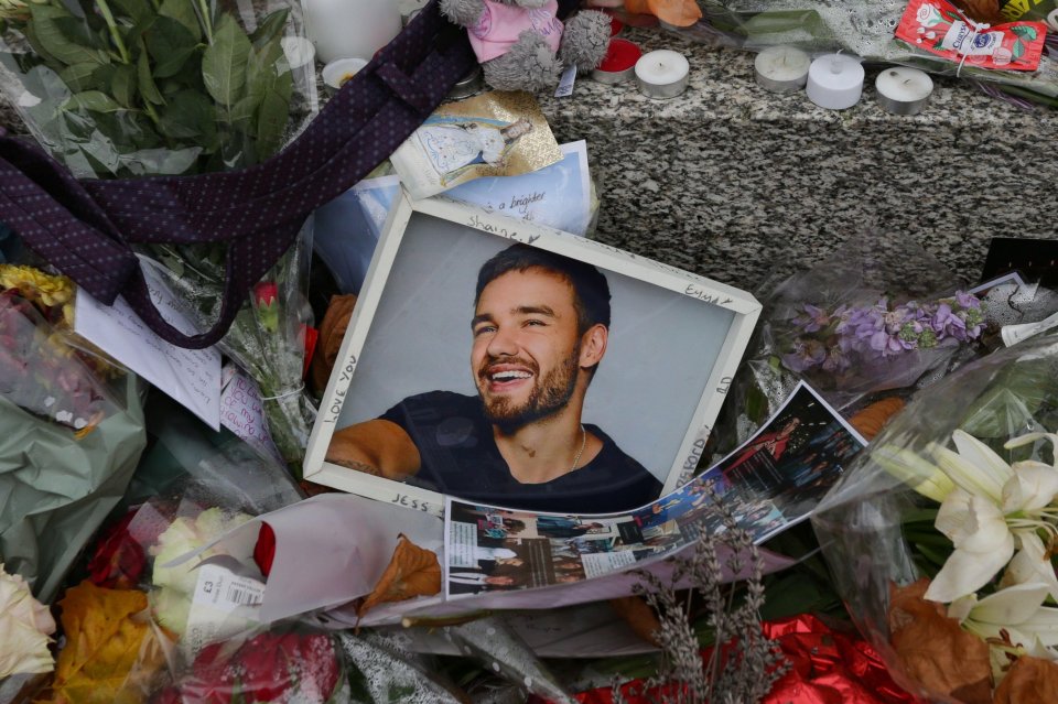 Flowers and photos left as a tribute to Liam Payne.