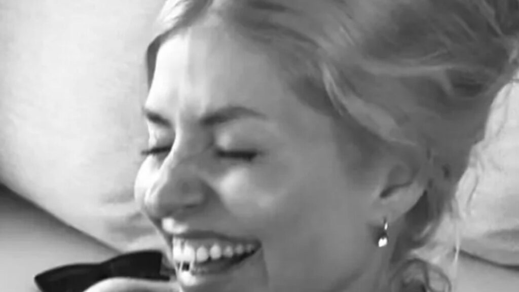 Holly Willoughby looks happier than ever as she poses in her bikini and cuddles two pals