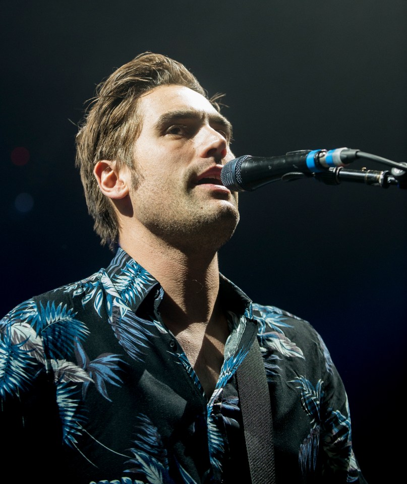 Charlie Simpson of Busted performing on stage.