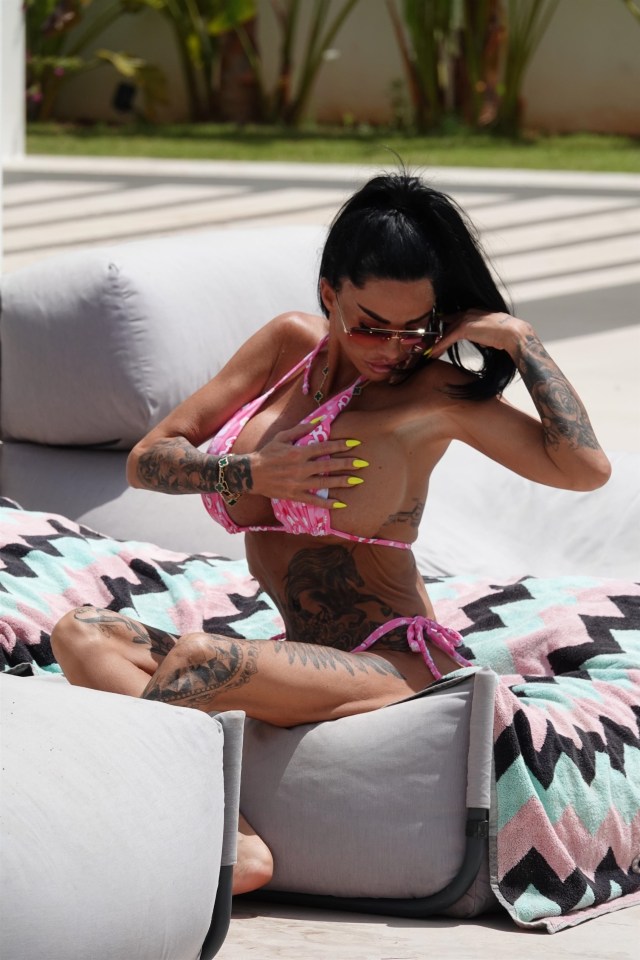 Katie Price in a pink bikini by the pool.