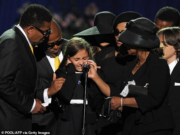 Paris surrounded by family at a memorial service for her dad on July 7, 2009