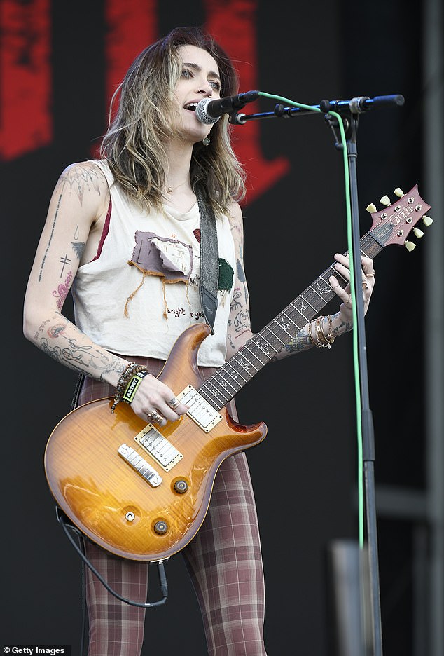 'It's just me and my acoustic guitar and my sound guy, who happens to be my fiance. So we¿re gonna be in a soccer mom van,' Paris said as she explained her modest tour accommodations; pictured on stage on May 27, 2023