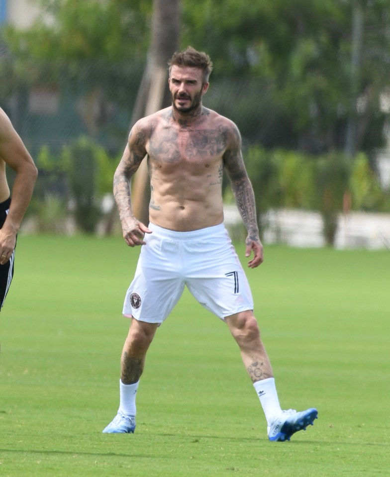David Beckham shirtless on a soccer field.