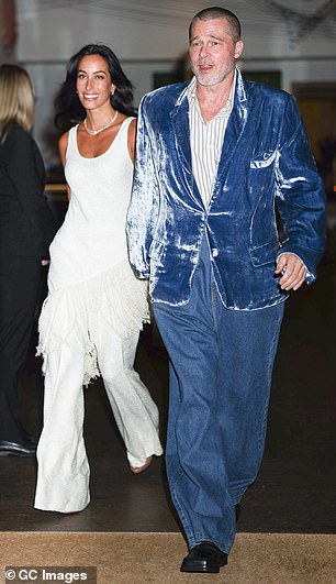 He additionally donned a partially buttoned, striped shirt underneath as well as a pair of black shoes