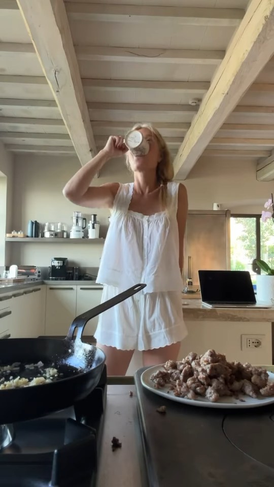 Gwyneth Paltrow in pajamas cooking in a kitchen.