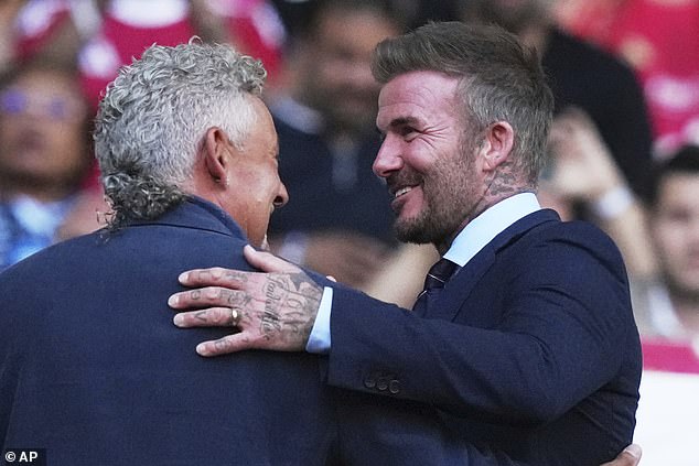 David was beaming as he hugged former football star Roberto Baggio at the match on Saturday