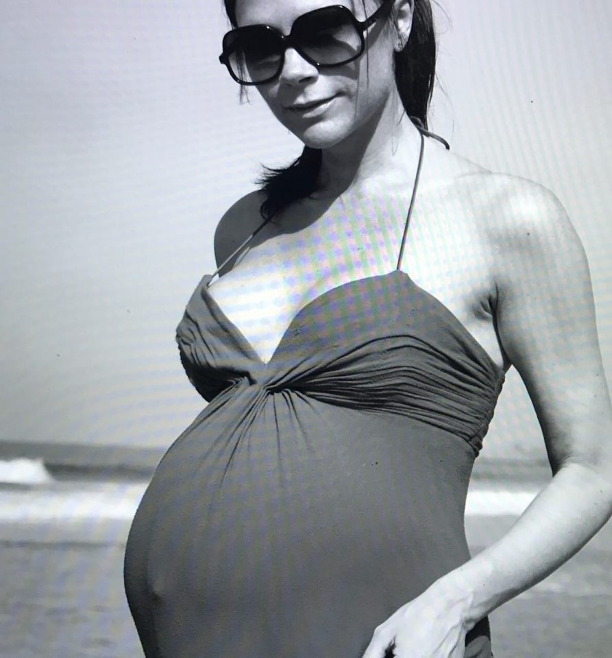 Black and white photo of a pregnant Victoria Beckham.