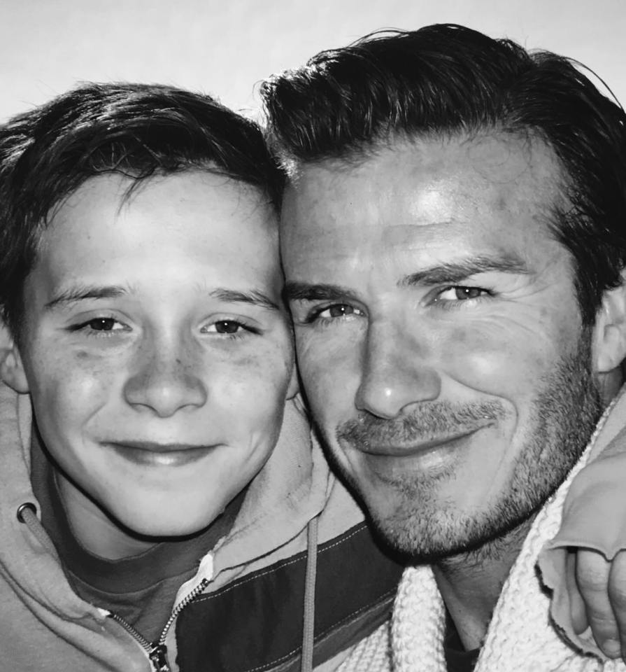 Black and white photo of David Beckham and his son.