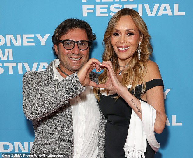 The headline-grabbing lovebirds happily posed for photographers while creating a love heart with their hands