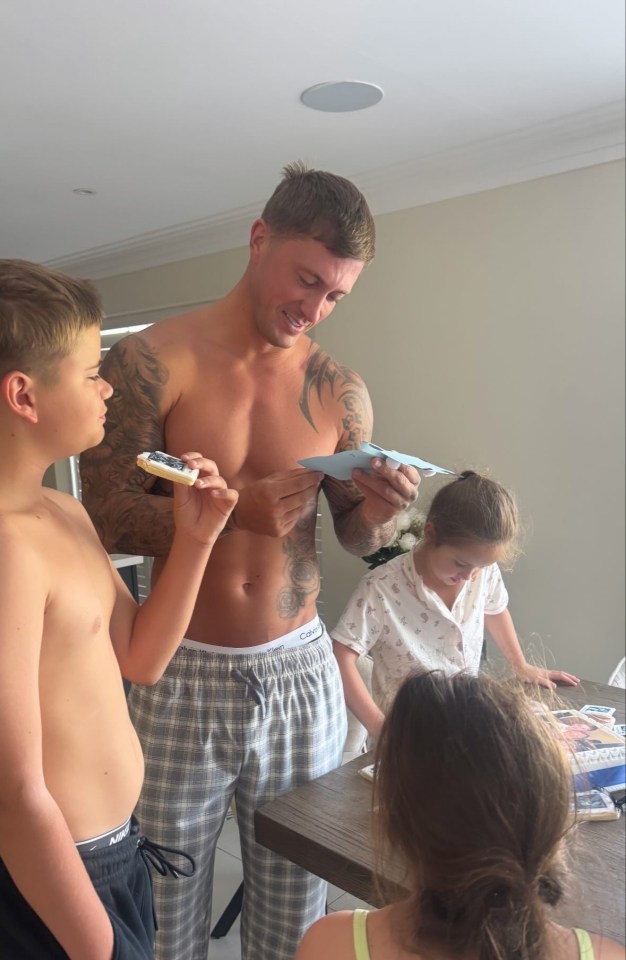 A man receives Father's Day gifts from his children.