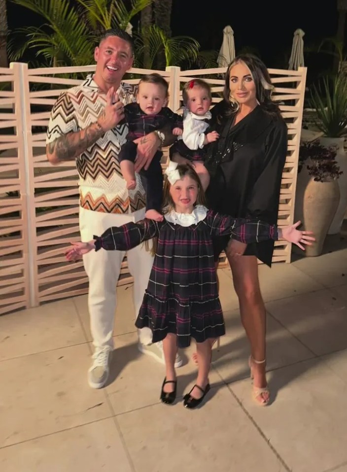Family portrait of a father, mother, and three children.