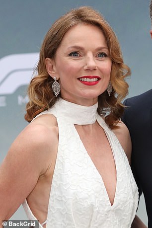 Geri opted for a bold red lip and styled her auburn locks in bouncy curls