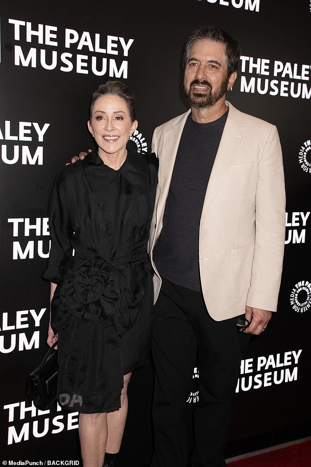 The actress, 67, looked typically chic in a black satin midi dress with a large collar and quirky belt detail