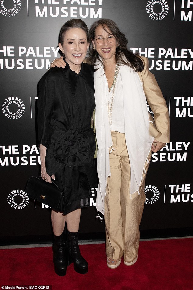 Maggie opted for a gold blazer and trouser co-ord, with a sheer white blouse underneath as she cuddled Patricia in on snap