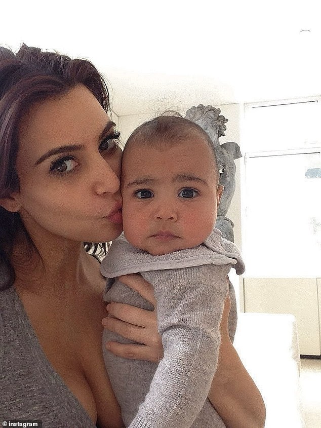 Kim wore her signature brunette locks loose around her