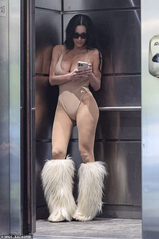 As she walked back to her brand-new Porsche 911 Turbo 4S, Censori appeared a bit distracted and glued to her iPhone
