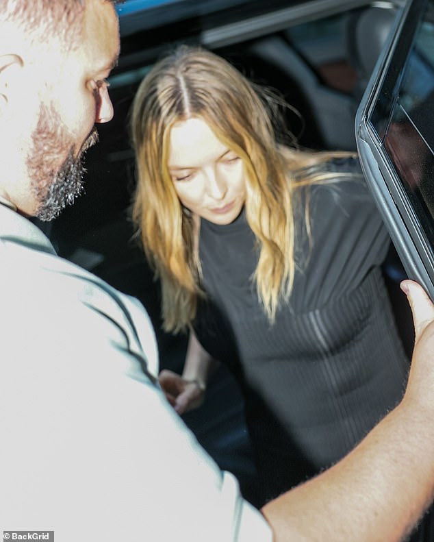Jodie was seen being helped out of chauffeured car by a bodyguard as she arrived for the talk in a boat neck black ribbed dress