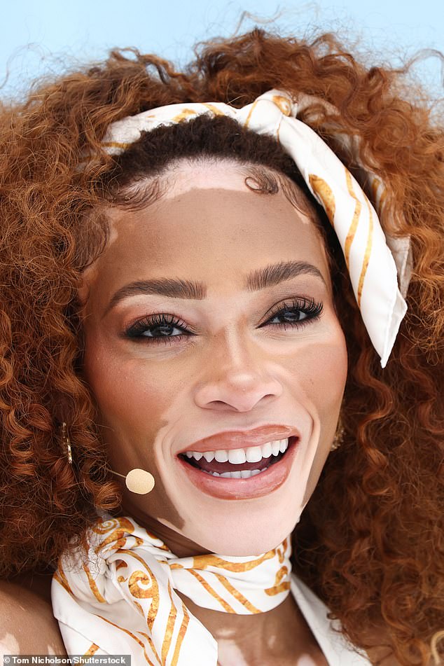 Winnie toted around her belongings in a white leather handbag as she completed her look with a white and orange neck scarf