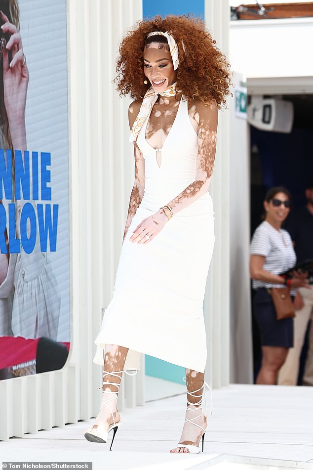 She added inches to her statuesque physique as she slipped into towering white strappy sandals